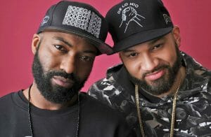 Two men smiling into the camera