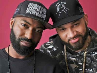 Two men smiling into the camera