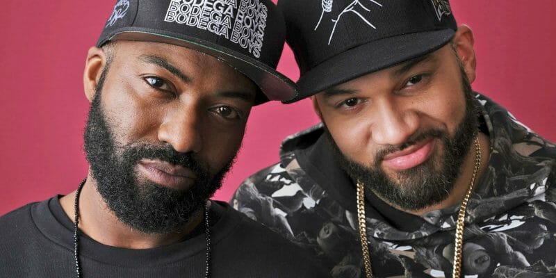 Two men smiling into the camera