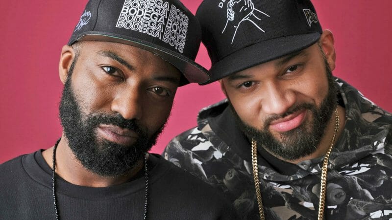 Two men smiling into the camera